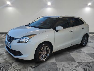 the white car is parked in the garage on a checkered floor