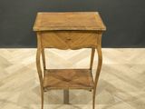 a small wooden table with a drawer on top of it