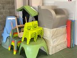 a pile of plastic chairs and chairs in a room