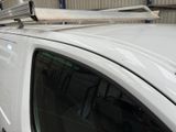 a white van with a surfboard on top of it