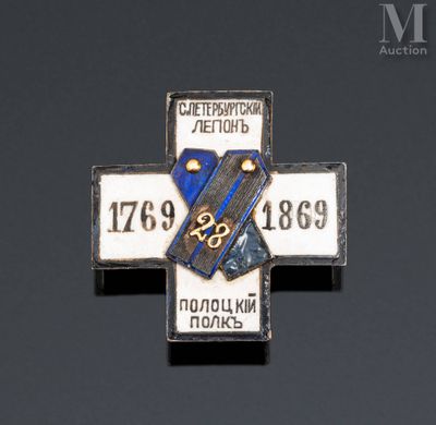 a close up of a metal cross with a blue and white stripe