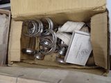 a cardboard box with a bunch of metal parts inside of it