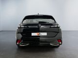 the rear end of a black car in a white room