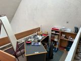 an image of a room with a desk and bookshelf