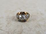 a close up of a ring with a diamond in it