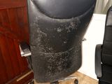 a black office chair sitting in front of a wooden door