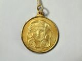 a close up of a gold coin with a woman ' s face on it