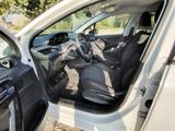 the interior of a car with the door open and the driver ' s seat up