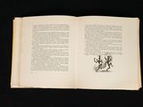 an open book with a drawing on it on a black surface