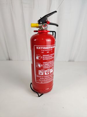 fire extinguisor on a white table with a white background