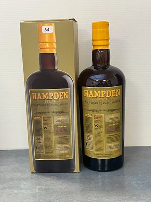 La bouteille de Hampden se trouve à côté de la boîte, sur la table.