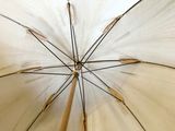 a white umbrella that is open on a sunny day