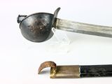 two different types of knives on a white surface