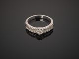 a close up of a diamond ring on a black surface