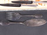 four forks, a knife, and a spoon in a box