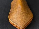 leather coin purse on a black background