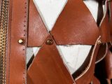 a close up of a leather jacket with a zipper on it