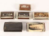 several different types of cigarette cases are lined up on a white surface