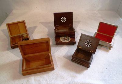 four small wooden boxes sitting on a white surface