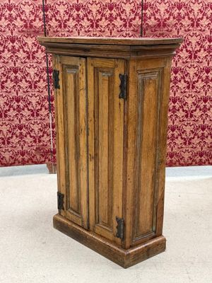 an old wooden podium with a microphone on top of it in front of a red wall