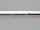 a close up of a metal pipe on a white surface