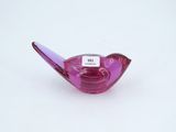 a small purple glass bird with a tag on it