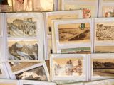 a lot of old photos on display on a table