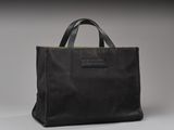 a black tote bag sitting on top of a table