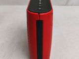 a red speaker that is sitting on a white surface