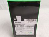 a close up of a box on a white surface with a green label