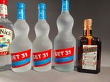 several bottles of alcohol are lined up on a table