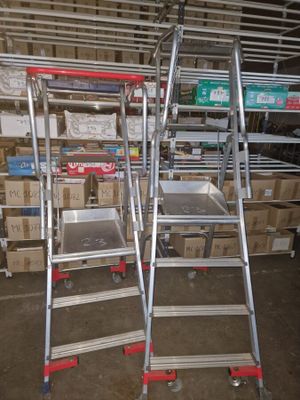 two ladders that are next to each other in a room