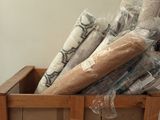 many rolls of toilet paper in a wooden box