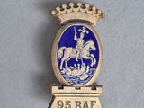 an image of a blue and gold badge with a man on a horse