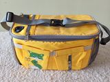 a yellow bag that has a green frog on it
