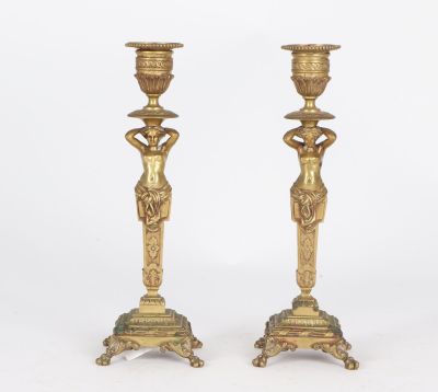 pair of antique brass candlesticks with female figures on pedestals