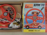 a box with a toy car and steering wheel in it