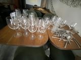 many glasses and spoons on the table ready to be served