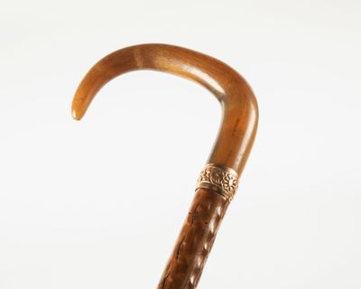a close up of a wooden umbrella with a metal handle
