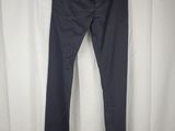 a pair of dark blue pants hanging on a white curtain