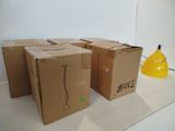 several cardboard boxes sitting on a counter with a yellow vase in the background