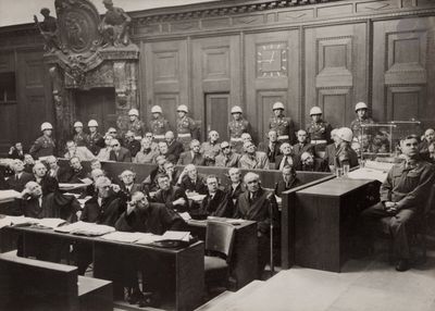black and white photograph of a large group of people sitting in a courtroom