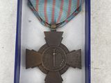 medal in a blue box with a ribbon and a cross on it