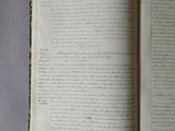 an open book with writing on it sitting on top of a table