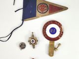 a pennant, pins, and other items on a table