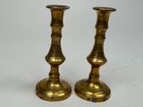 pair of antique brass candlesticks on a white background