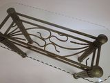 a glass table with a metal frame on top of it
