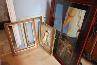 two framed pictures of a woman and a man on a sailboat