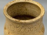 a stoneware vase with a brown glaze on it