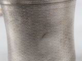 a silver cup that is sitting on a table
